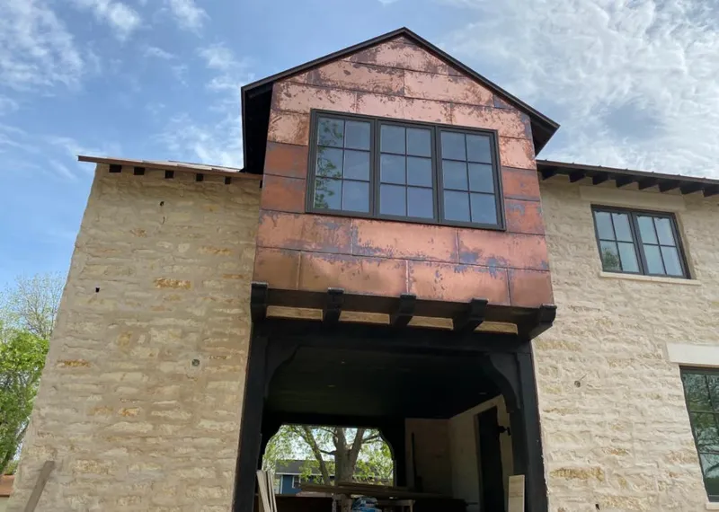 Copper metal panel facade on a stone building for Skylight Installation in West Dundee